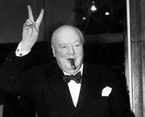 Churchill with a cigar in his mouth and a peace sign